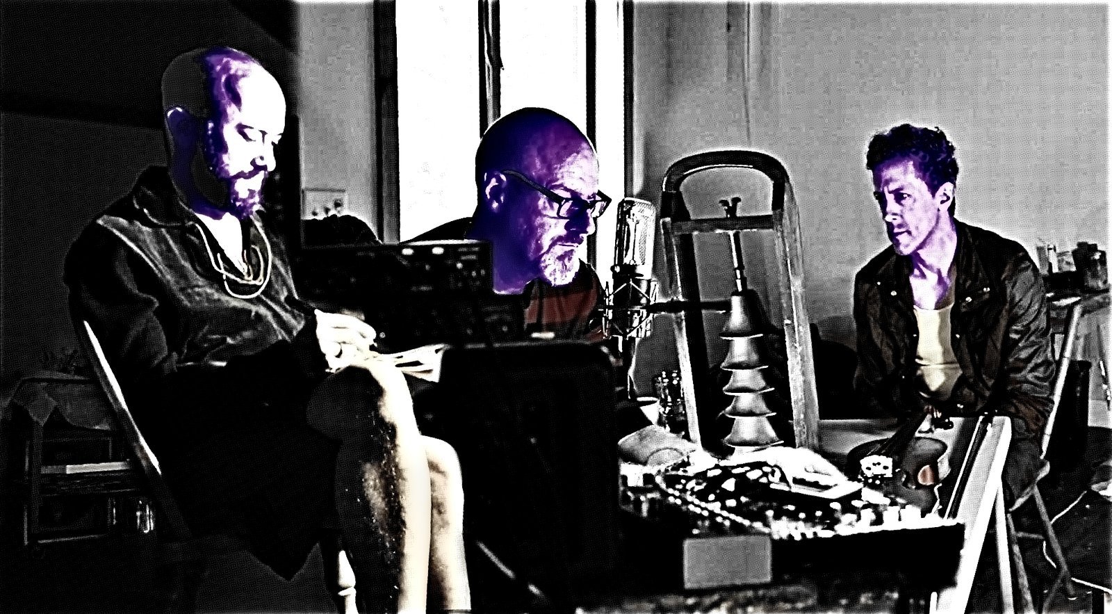 The three members of The Children… sitting around