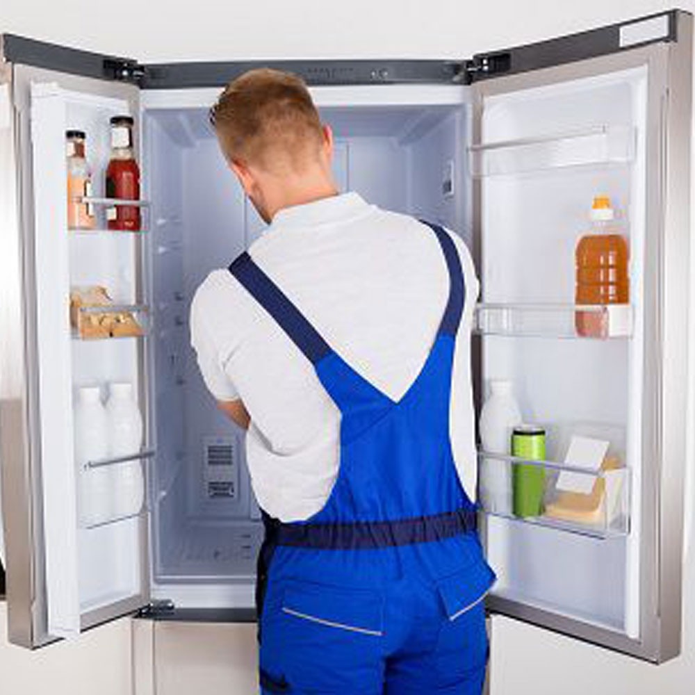 Refrigerator repair service technician