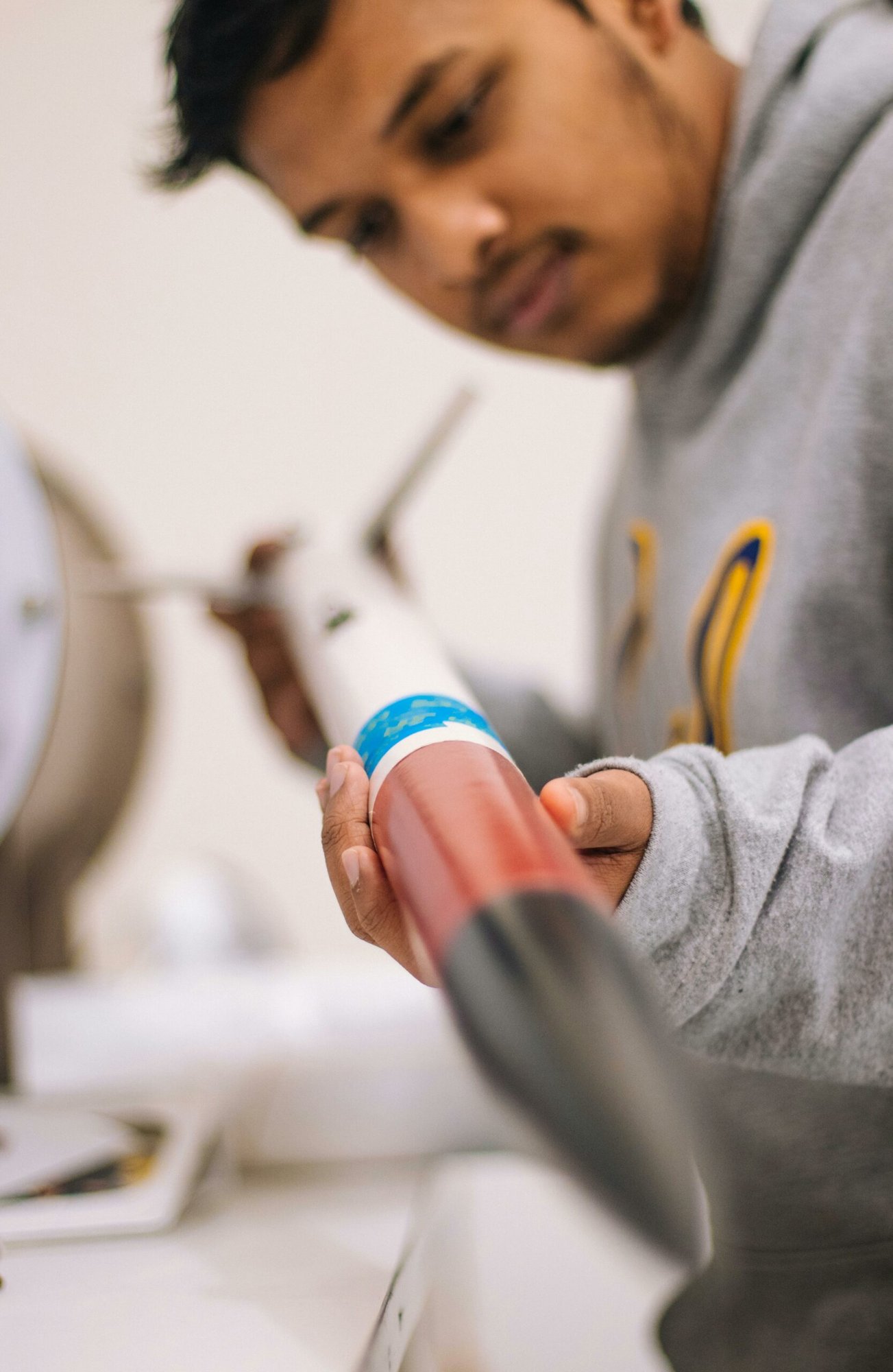 Engineer looking at scale model rocket Engineer looking at a scale model of a rocket.