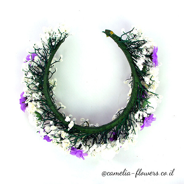 A flower crown with purple and white flowers available for delivery from a floral shop.