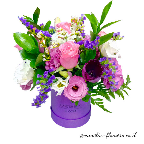 A flower arrangement in a box delivered by a floral shop.