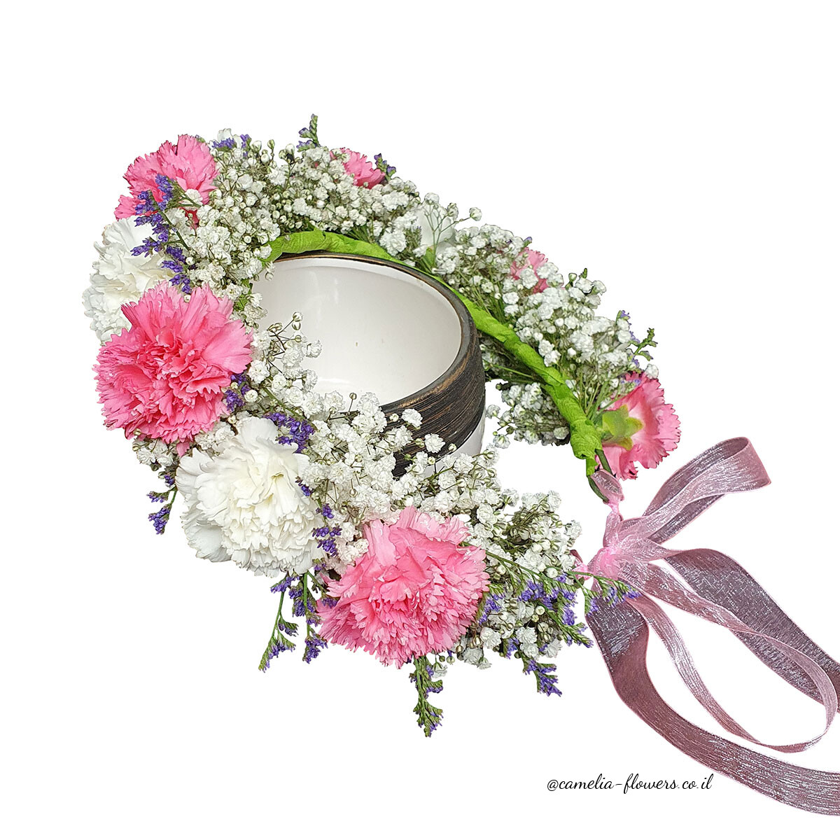 A flower crown with pink and white carnations available for delivery at a floral shop.