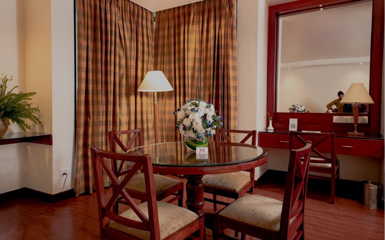 A view of the City Park Hotel room featuring a table and a flower pot