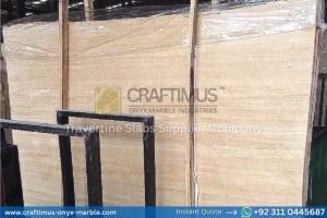 Stacked beige travertine stone slabs