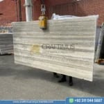 Silver Travertine Slabs Stacked in Factory