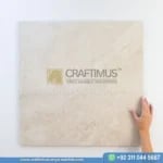 Light beige travertine tile product image with a hand and logo watermark and whatsapp number