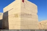 Classic Beige Travertine Blocks at a factory in Pakistan in background