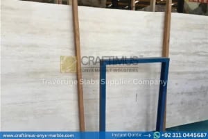 Stacked beige travertine stone slabs