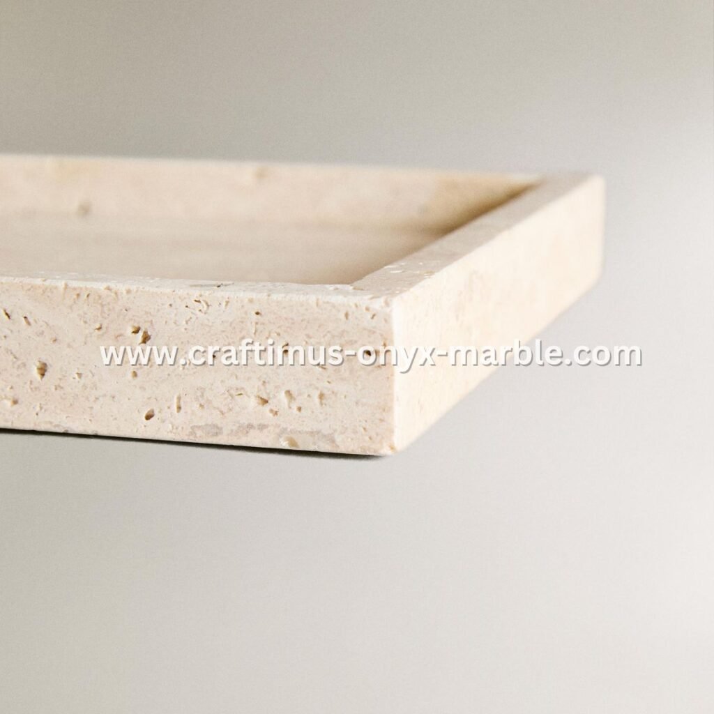 Handcrafted travertine rectangular tray with a textured natural stone surface and visible organic holes, designed as a multipurpose decorative platter for serving food, organizing bathroom essentials, or holding accessories on dining tables, kitchen counters, or vanity spaces.