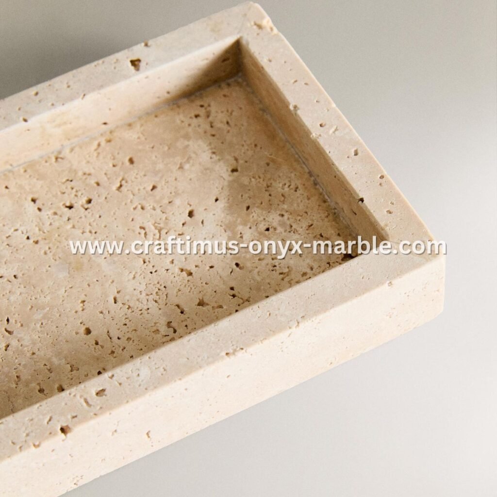 Handcrafted travertine rectangular tray with a textured natural stone surface and visible organic holes, designed as a multipurpose decorative platter for serving food, organizing bathroom essentials, or holding accessories on dining tables, kitchen counters, or vanity spaces.