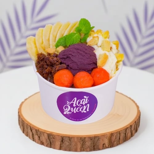 Tropical vegan acai bowl with banana, mango, and coconut, healthy plant based dessert from Acai Queen Bar Ubud and Kuta Bali cafe.