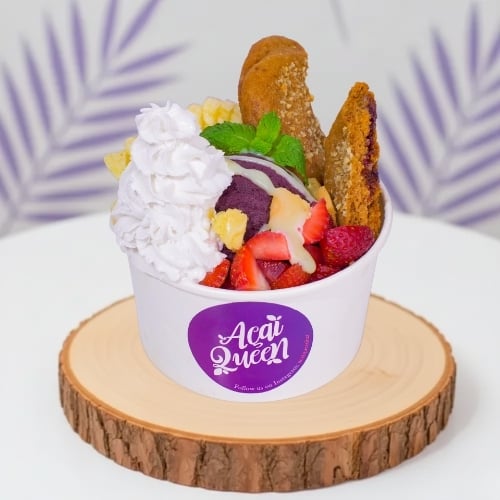 Healthy vegan acai bowl filled with tropical fruits, plant based smoothie dessert from Acai Queen Bar Ubud and Kuta Bali.