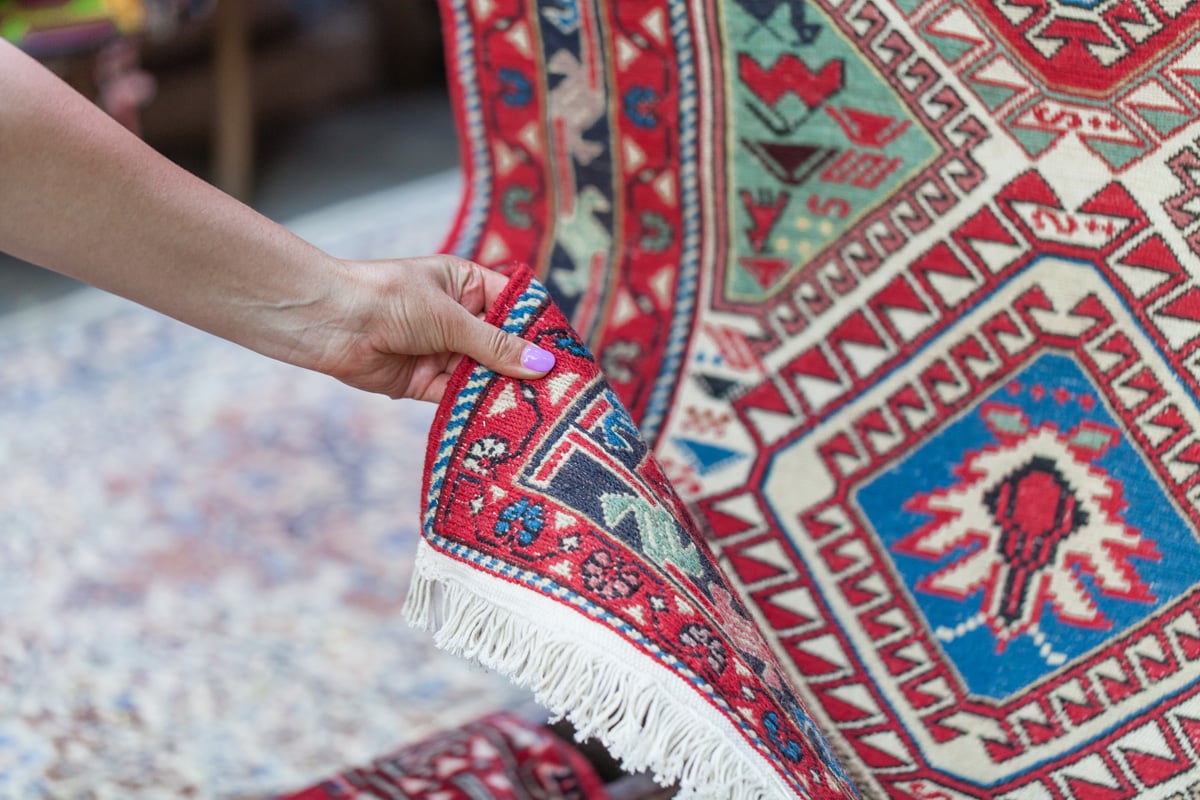 oriental rug woman's hand touching oriental rug