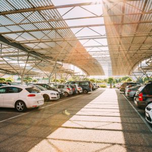 Cars on a covered parking lot in sunny summer day Cars on a covered parking lot in sunny summer day