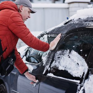 Frozen car door. Automobile car door or lock is frozen shut. Man driver trying to open frozen car Frozen car door. Automobile car door or lock is frozen shut. Man driver trying to open frozen car