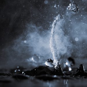 Boiling water splash with steam on black background closeup Boiling water splash with steam on black background closeup