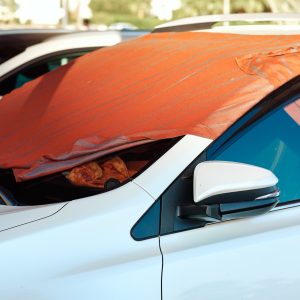Sun shade made of blanket on car windshield Sun shade made of blanket on car windshield