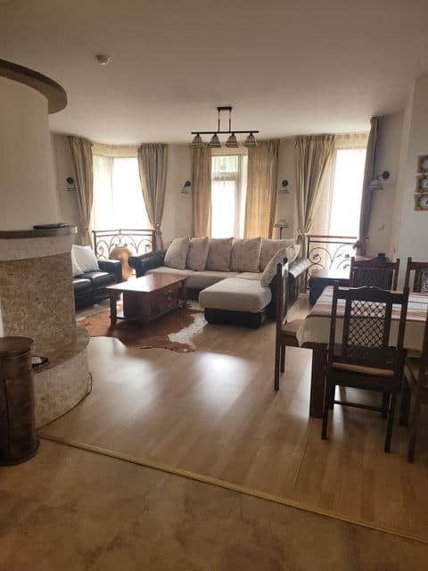 A living room with wooden floors and a couch.