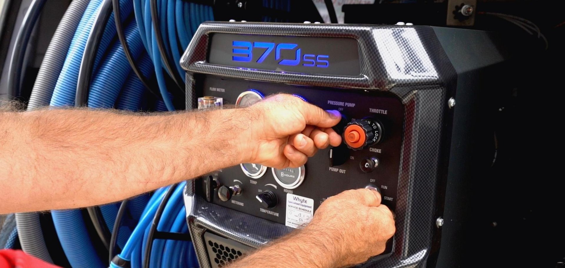 Commercial Cleaning 3 AustClean technician adjusts controls on 370SS exterior cleaning machine – professional pressure washing and surface cleaning equipment, ready for residential or commercial cleaning in Australia.