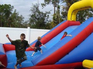 backyard slide water event birthday party rental orange city blue red yellow