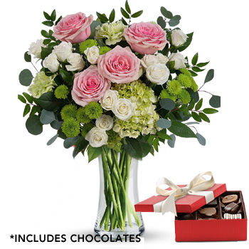 vase with mixed flowers and box of chocolates
