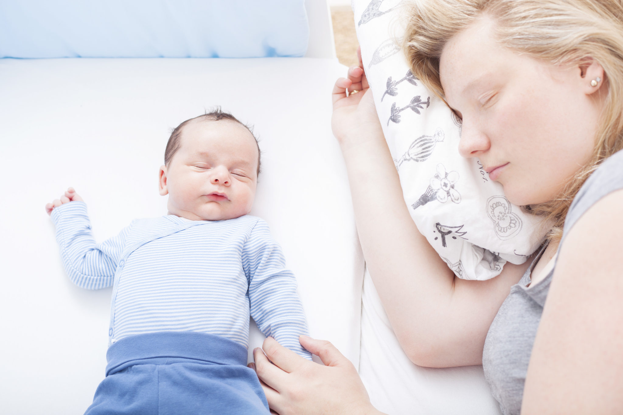 mother sleeping with baby.