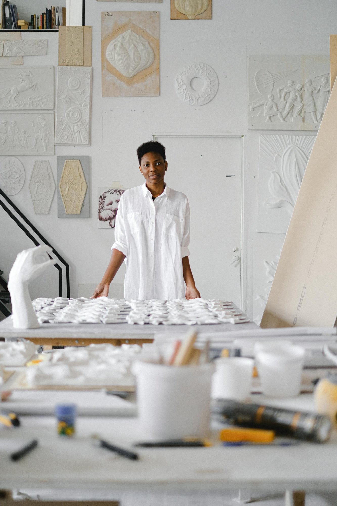 Photo by Anna Shvets Portrait of an artist working with ceramics in a bright studio space.