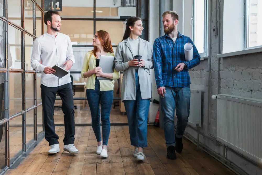 a group of people walking in a room to discuss exit planning