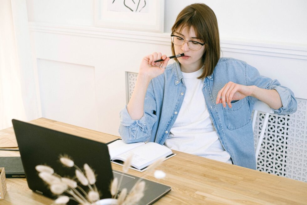Marketer sitting at her computer and asking how often do I need to publish blog content?