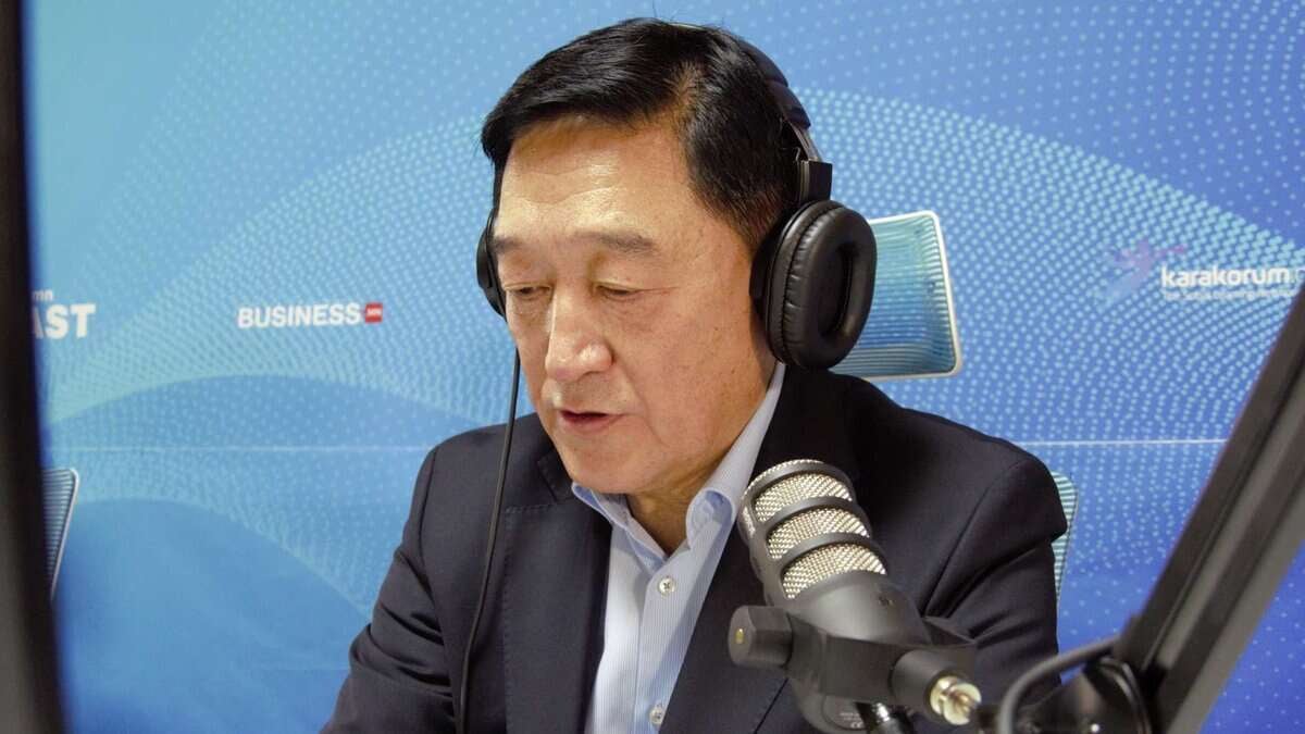 Костюм, чихэвч өмссөн бизнес эрхлэгч, дуу үл нэвтрэх өрөөнд микрофоноор ярьж байна. - Business.MN