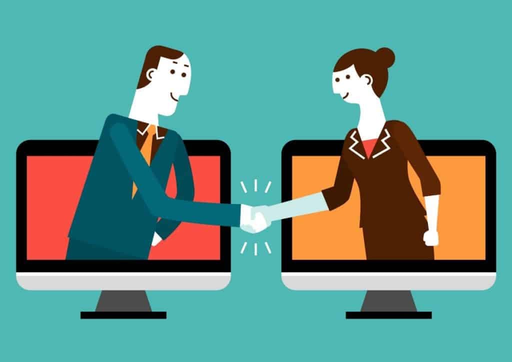 Виртуал тохиролцоо эсвэл уулзалтыг бэлгэддэг компьютерийн дэлгэцнээс гар барихаар гараа сунгаж буй хоёр предпринимателийн зураг. - Business.MN