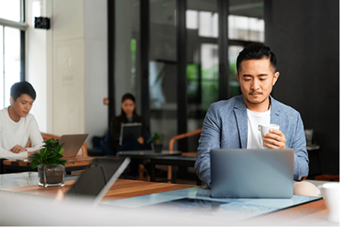 Three employees working using laptops