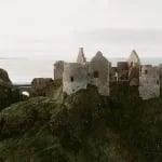 Ireland old medieval ruins of Dunluce Castle on ocean coast in northern Ireland famous place in uk