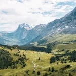 swiss alps mountain filled with trees during daytime
