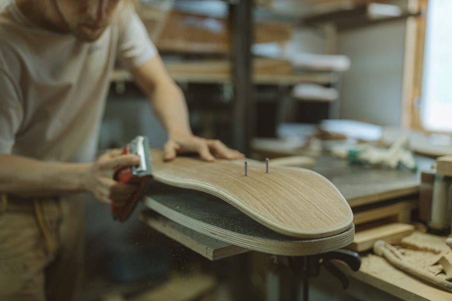 Best Tips To Making THOUSANDS As A Woodworker! 3 A man making a skateboard