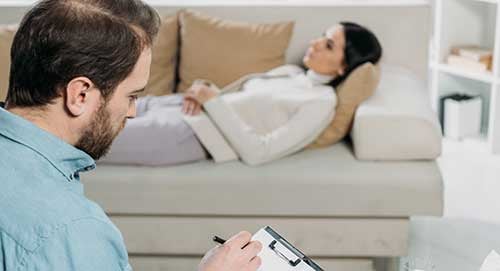 Hypnotherapist helping client