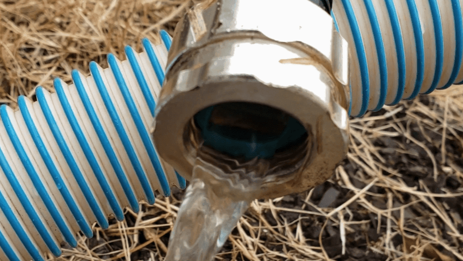 End of a water hose draining water.