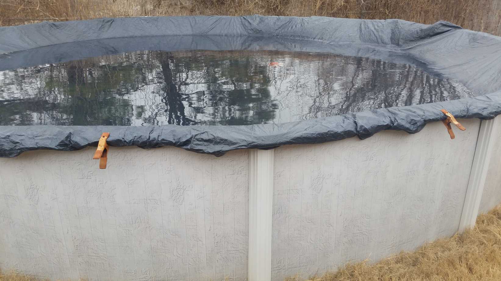 Above ground swimming pool with the winter cover over it.