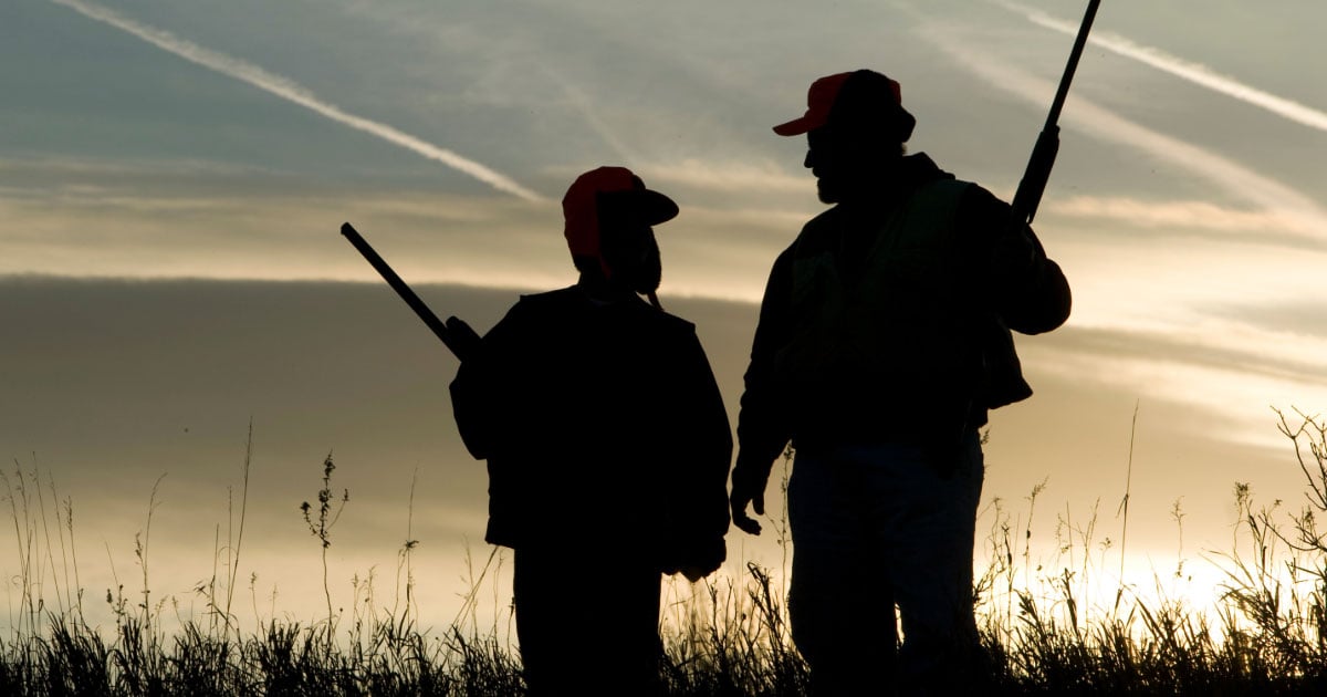 Father and son on hunting trip shadow silhouette