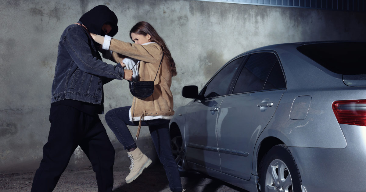 Woman defending herself against an attacker in parking lot