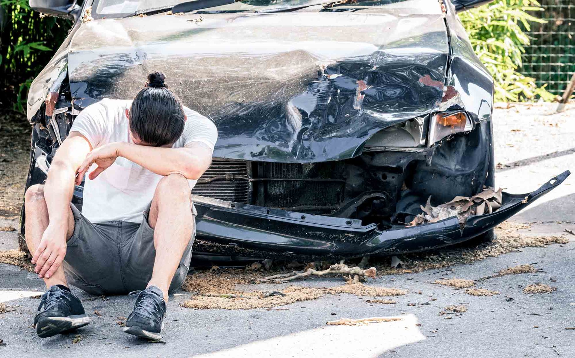 person in front of a car crash