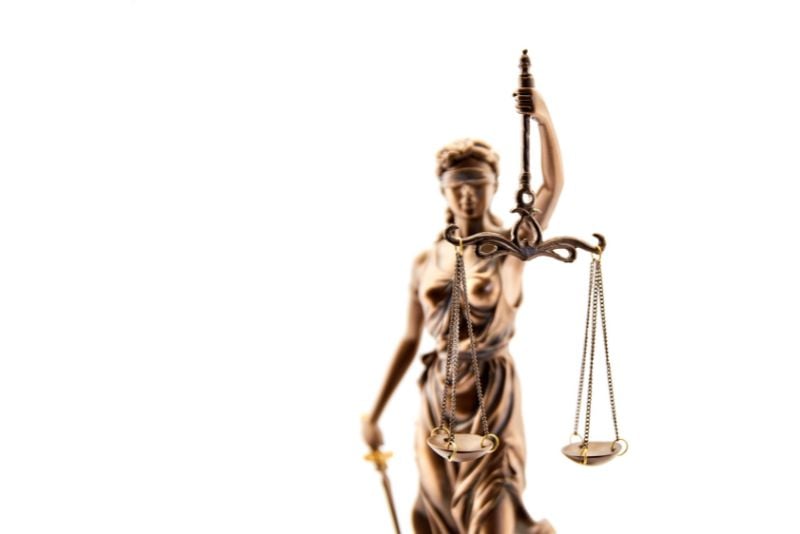 bronze statue of lady justice holding scales of justice