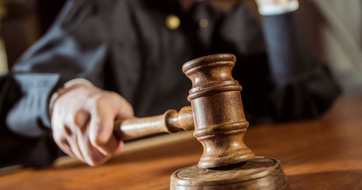 Judge slamming down gavel in courtroom