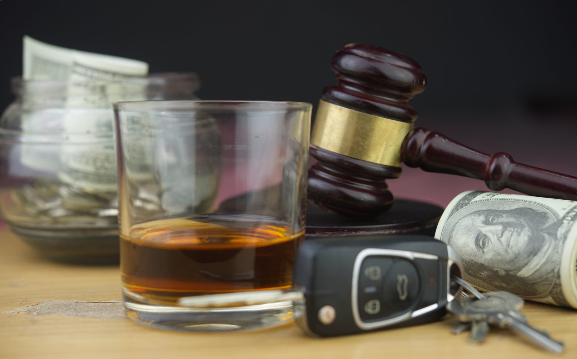 whiskey glass, keys, gavel, and money