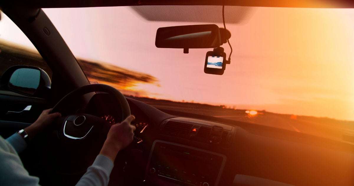 Woman driving into the sunset on Arizona highway
