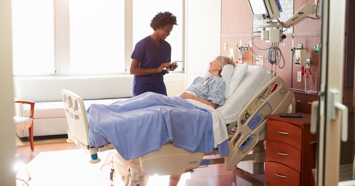 Older woman injured in accident being cared for by nurse in hospital