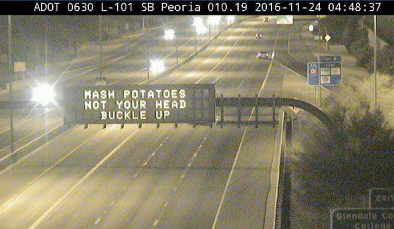 ADOT freeway sign that says, "Mash potatoes not your head buckle up"