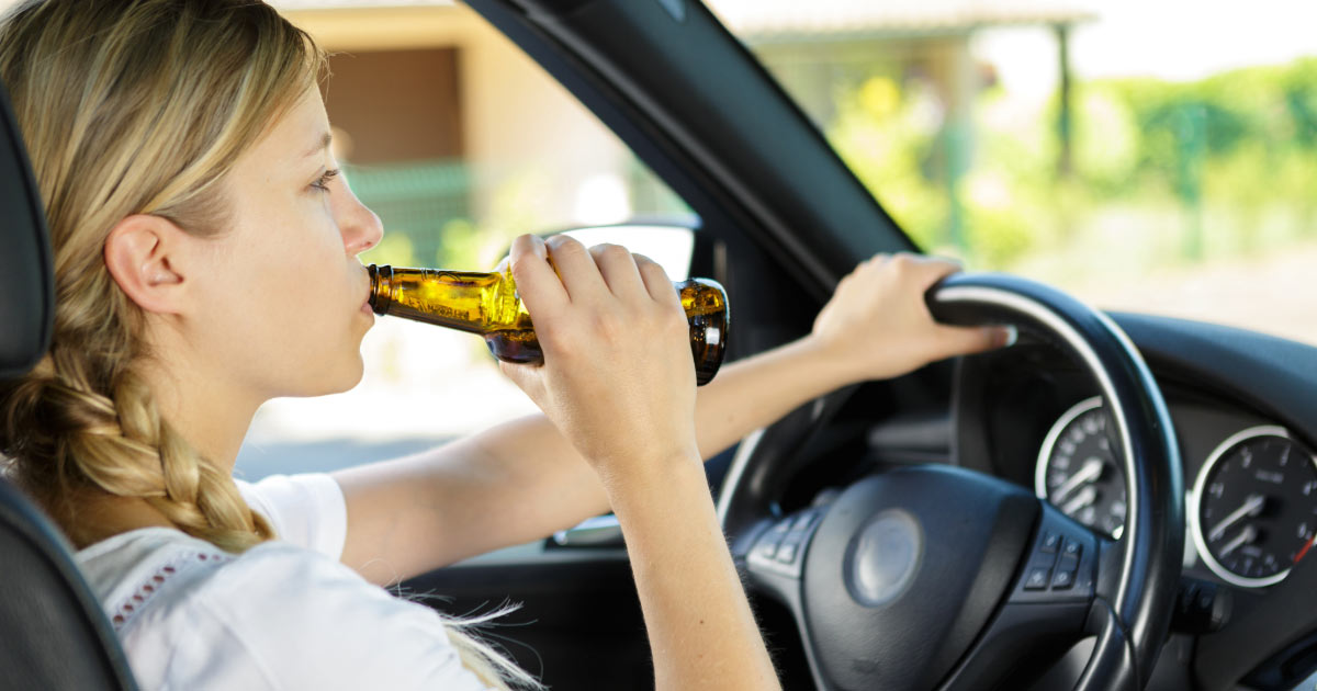 Teen girl drinking beer while driving