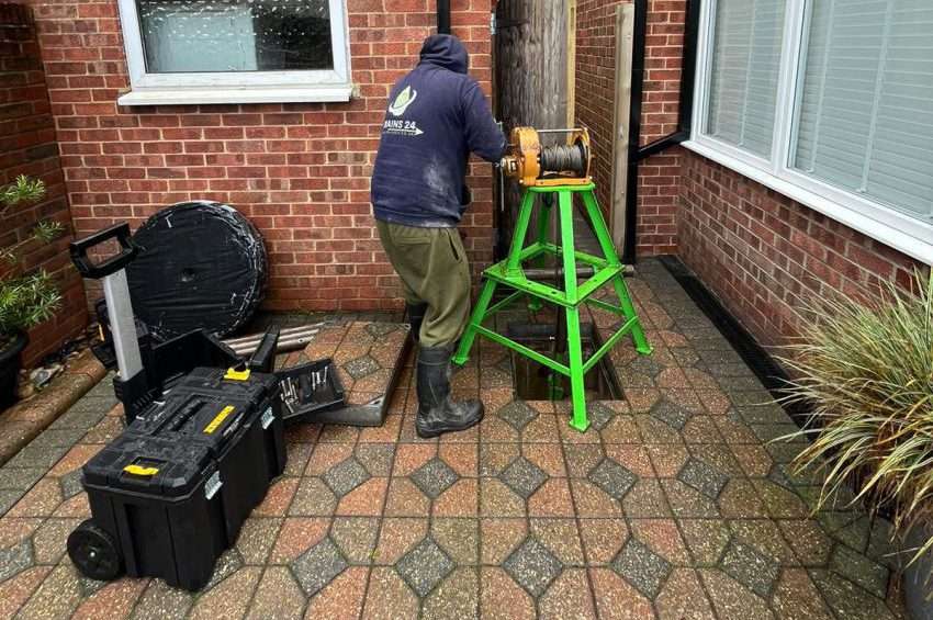 Technician installing CIPP drain liner inside residential pipe in Kingston Upon Thames — no-dig drain repair process.