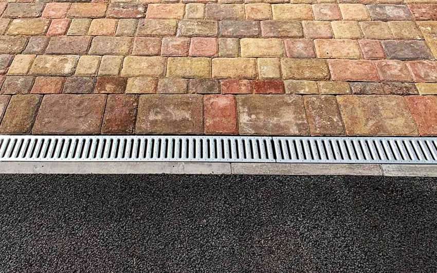 ACO drain on a Kingston driveway showing how debris and surface water can cause blockages